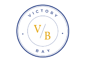 Logo of Victory Bay: a blue circular seal with the words 'VICTORY BAY' around the edge and gold initials 'VB' in the center.